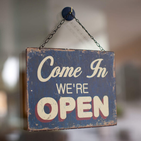 We're Open hanging sign
