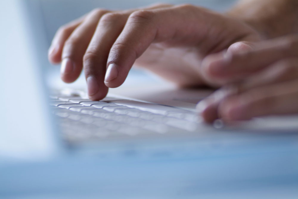 Hands typing on keyboard