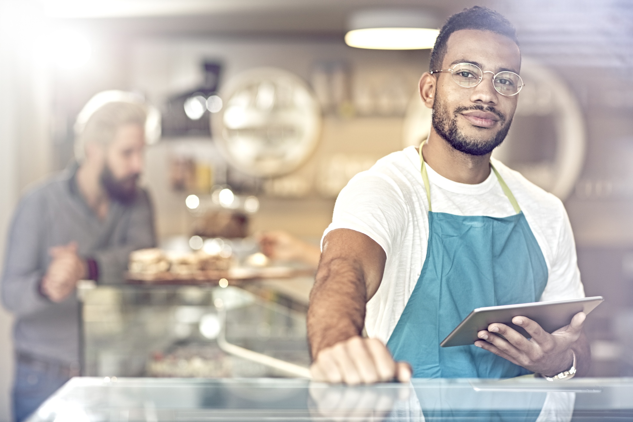 Cafe employee holding tablet