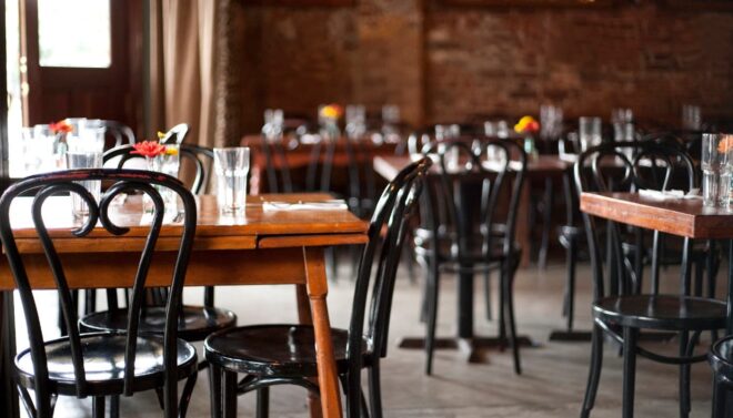 Tables and chairs in empty restaurant