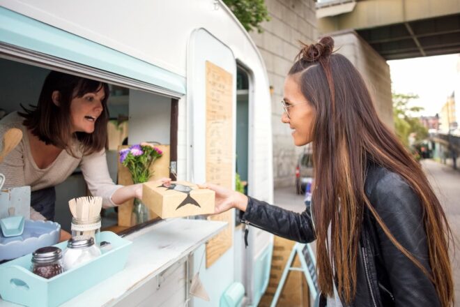 Food truck owner serving customer