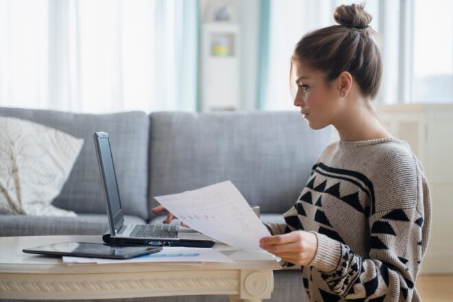 Woman entering information on laptop