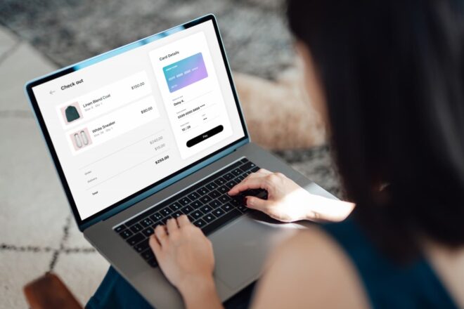 Woman looking at online order checkout page on laptop