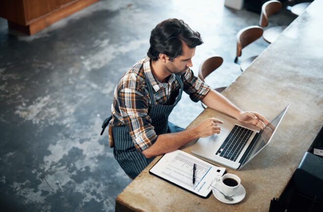 Restaurant owner working on laptop