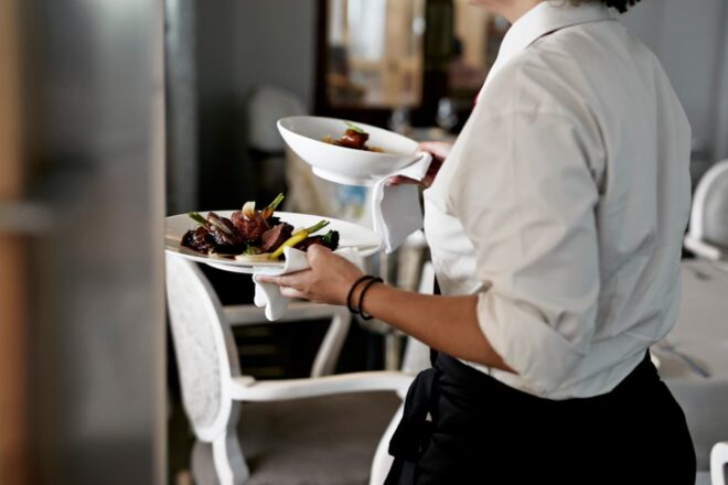 Restaurant server carrying entrees