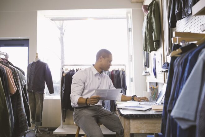 Man looking at laptop in retail store