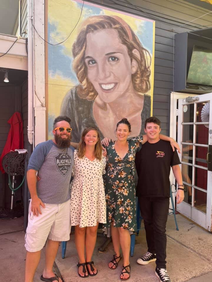 Family in front of painting of Mary
