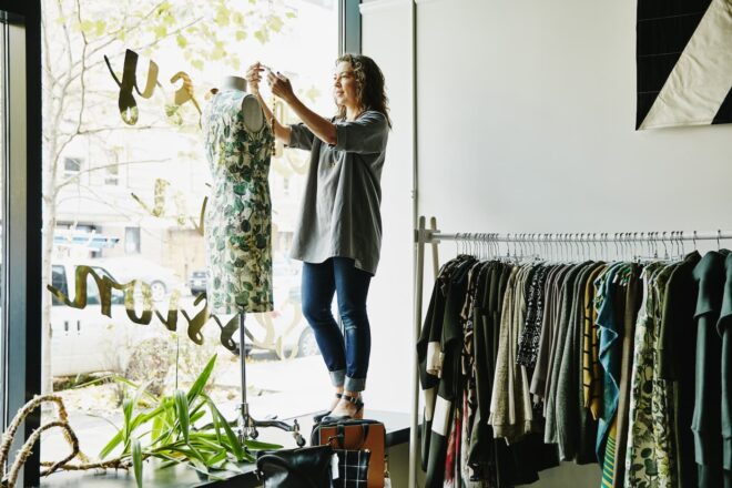 Woman dressing clothing form at boutique