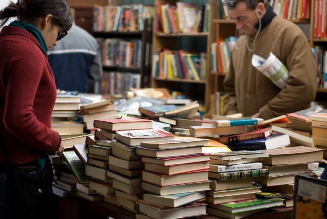 People sorting through books at bookstore