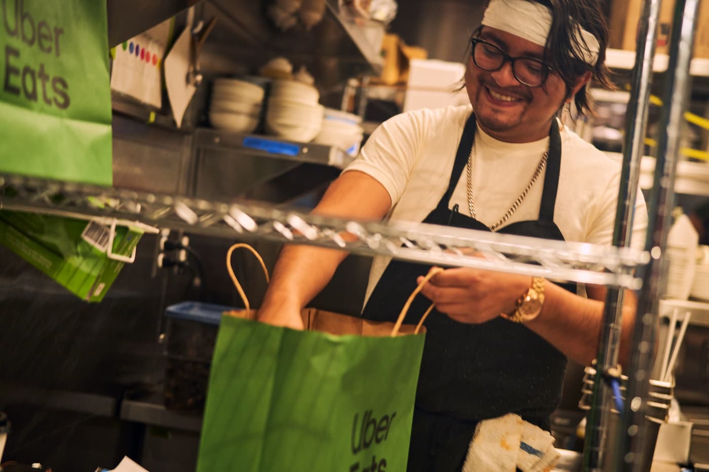 Restaurant worker packing Uber Eats bag