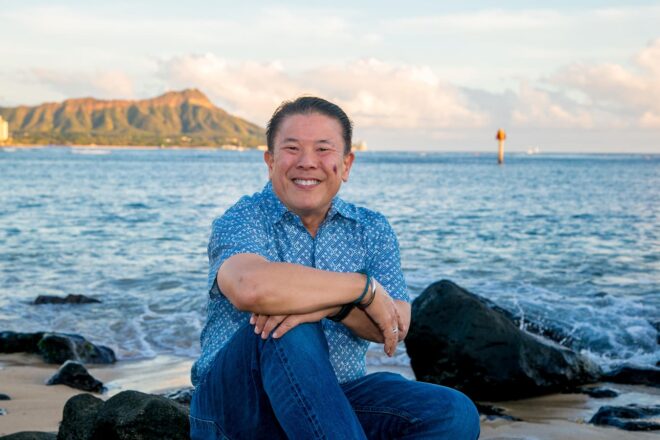 Owner of Enchanted Lake Pet shop sitting by the ocean