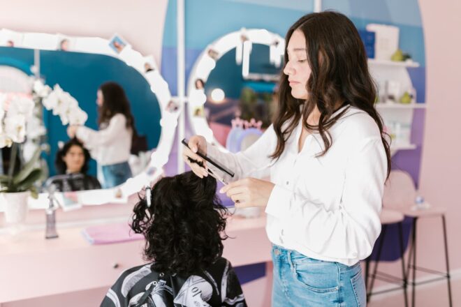Stylist working on client's hair at salon