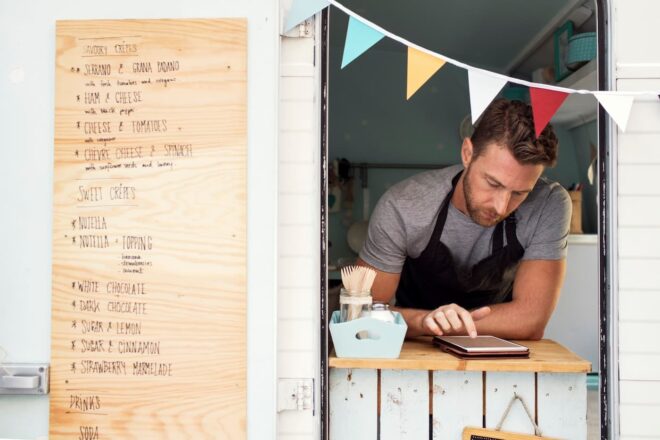 employee taking counter order at outdoor pop-up restaurant